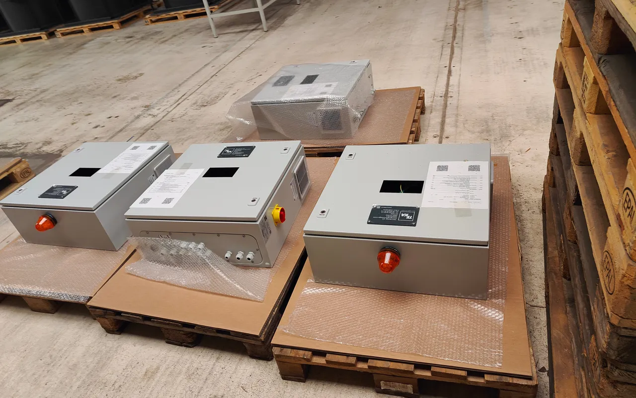 Finished control boxes packed on pallets, ready to ship