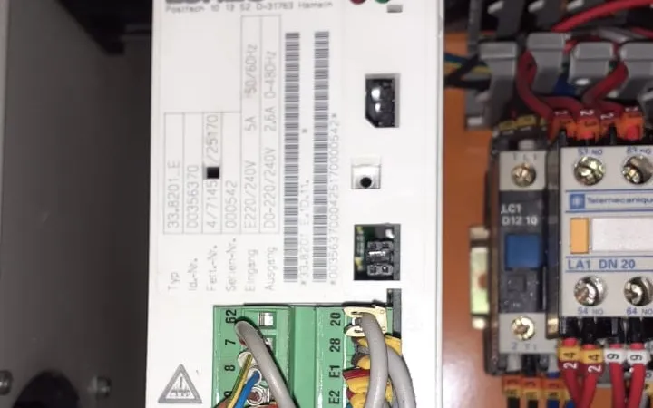 Close-up of a drive rating label beside contactors in a cabinet