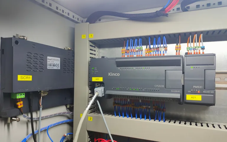 Controller and expansion modules in a packaging machine cabinet
