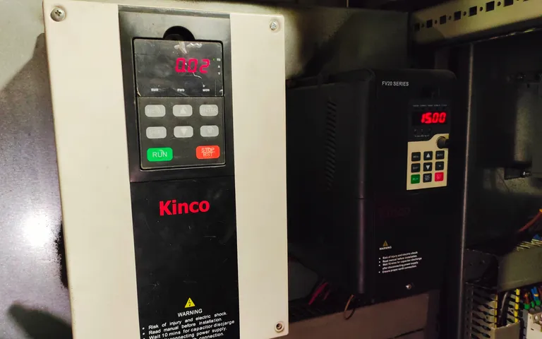 Close view of PLC input and output terminals wired inside a panel