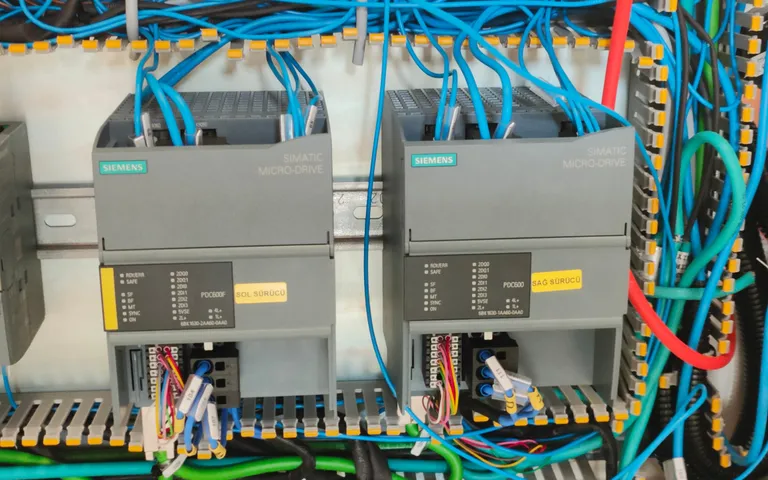 Two installed controllers from another manufacturer wired into a machine cabinet