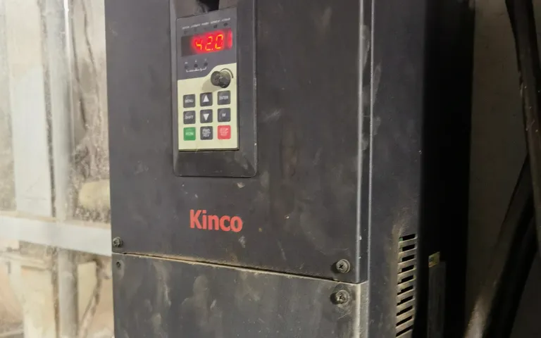 Weathered variable-frequency drive mounted in the open, still in service