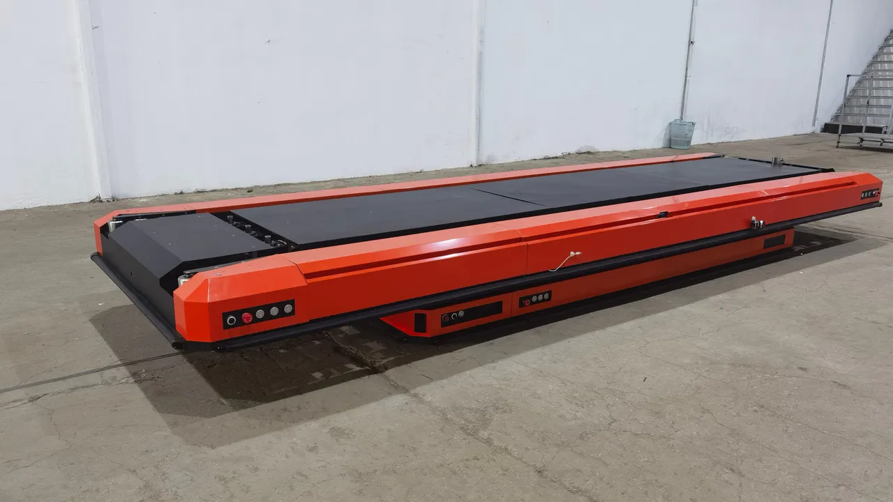 Low-profile transfer shuttle standing on a workshop floor