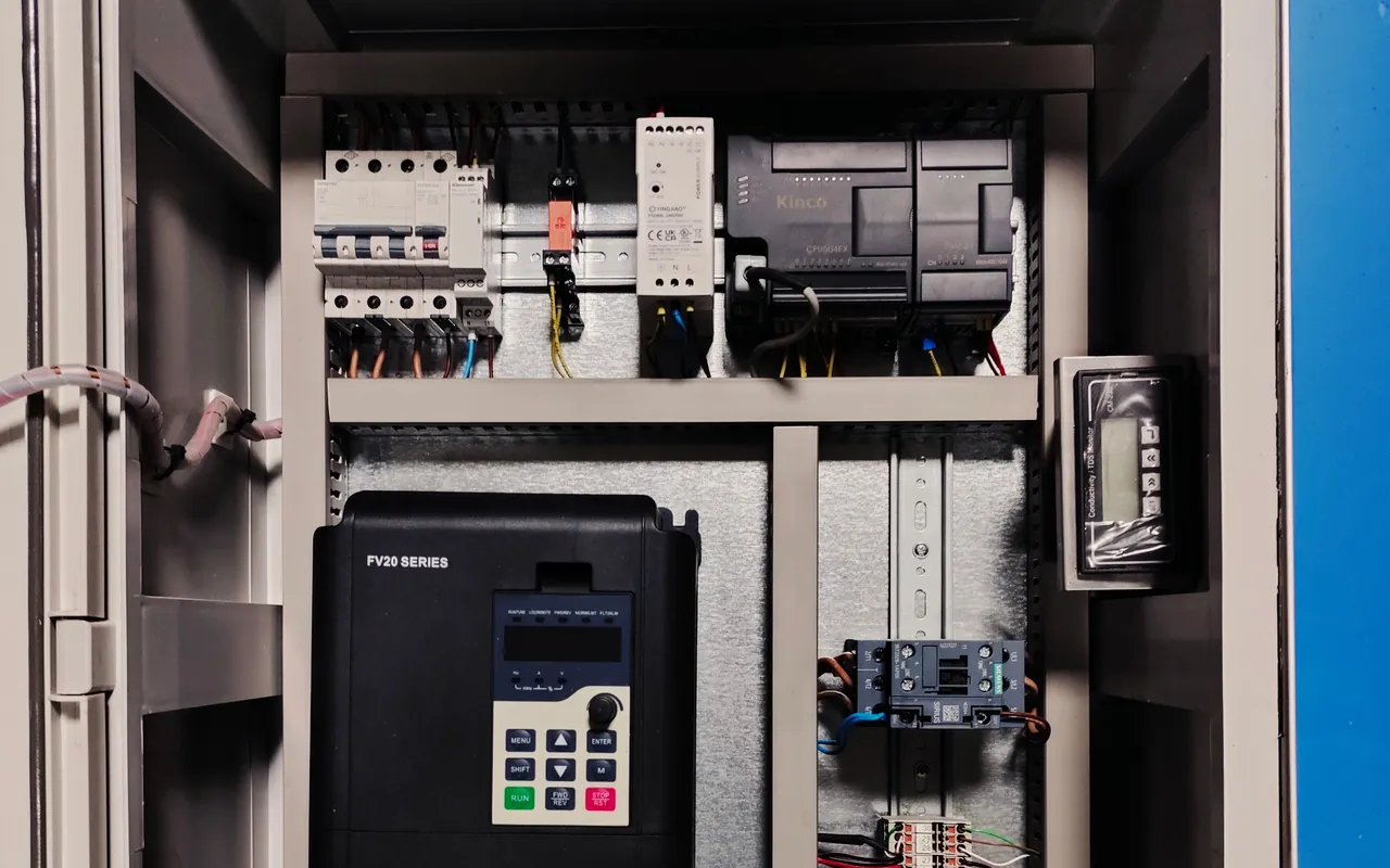 Control cabinet on a medical water-treatment skid: breakers, a variable-frequency drive and a controller